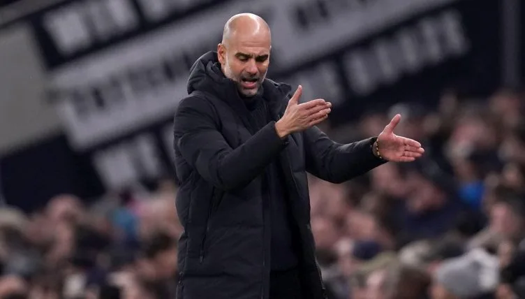 Image shows Pep Guardiola sighing in frustration during Tottenham Hotspur v Man City