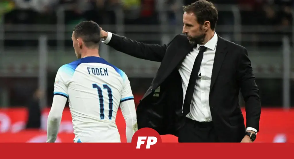 This image shows England manager Gareth Southgate giving Phil Foden instructions