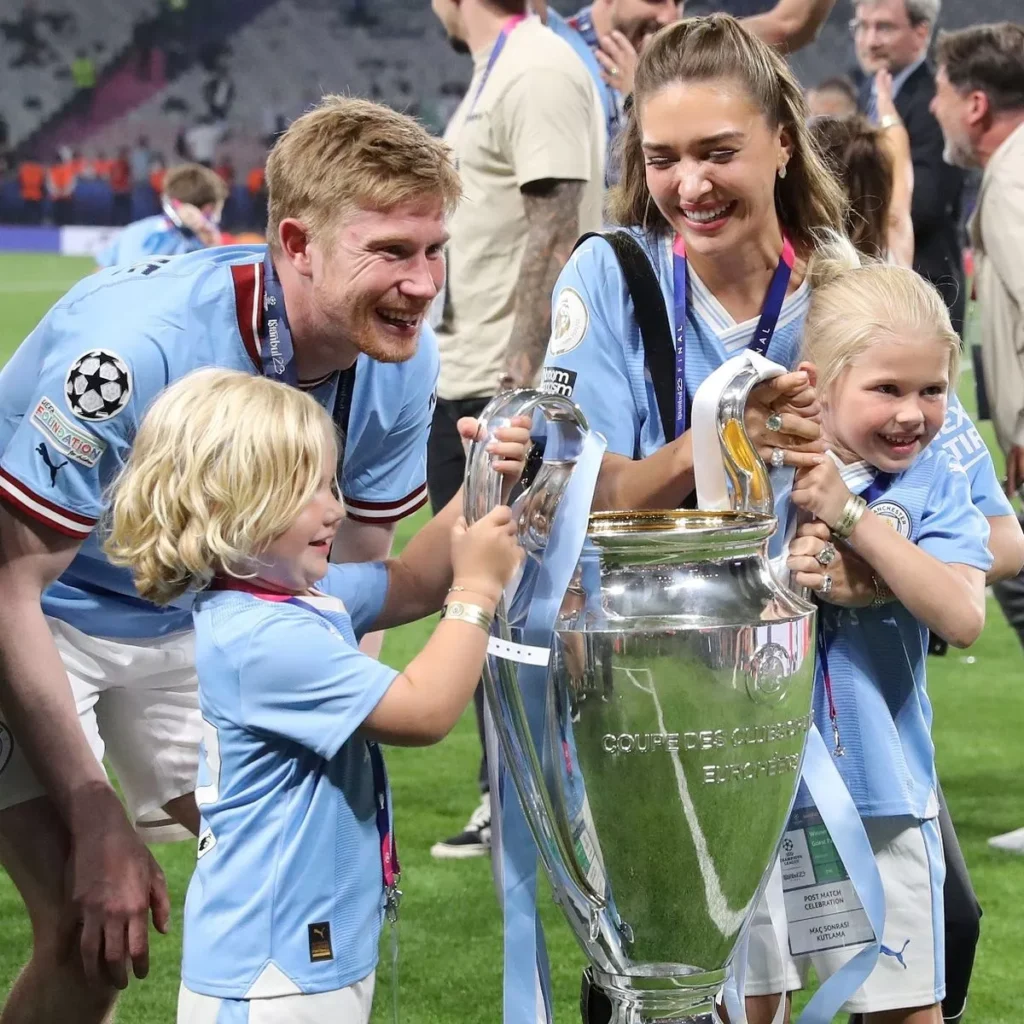 Kevin De Bruyne pictured with the Champions League trophy alongside his wife and two daughters.