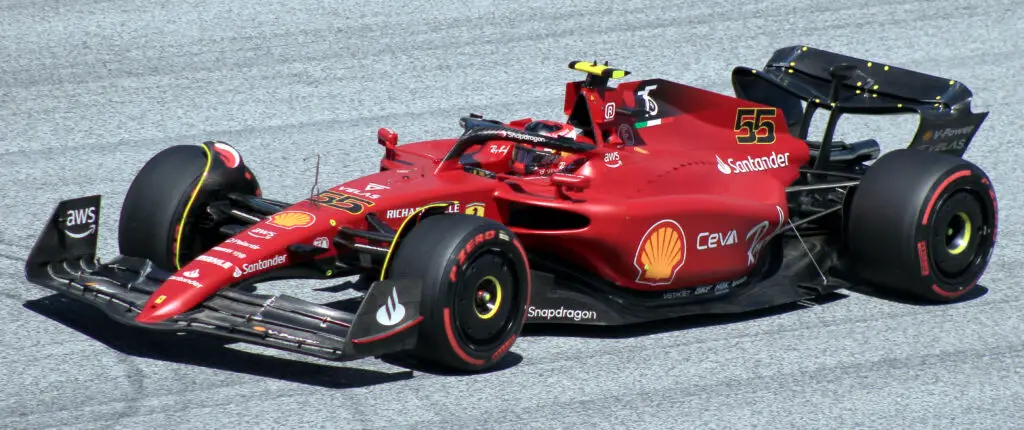 Carlos Sainz driving the Ferrari Formula 1 car around the track.