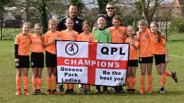 Toby Green and the Queens Park Ladies Under 12s all-girls football team who won the Bournemouth Youth League Division 3 this season. 